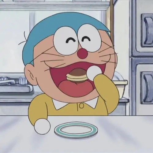 Doraemon cười ngoác miệng bên bàn ăn, Nobita phía sau tạo không khí rộn ràng như một pha tấu hài gia đình vừa bật ra