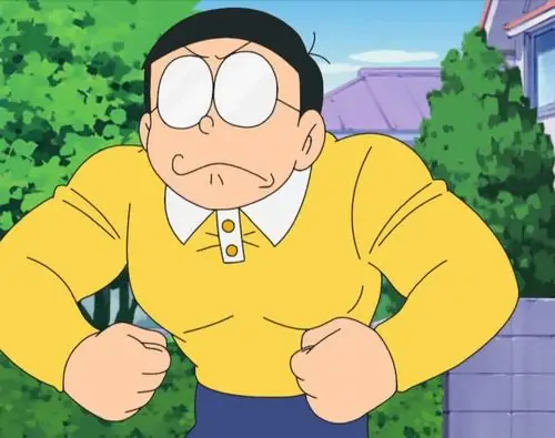 Nobita nắm chặt tay đứng trước kệ sách, gương mặt đỏ và lông mày nhíu hùng hổ như chuẩn bị cãi tay đôi với cả thế giới