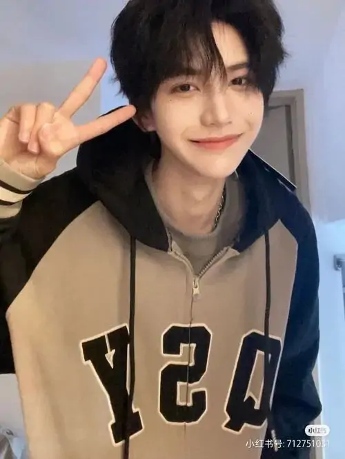 Nụ cười tươi tắn cùng biểu cảm giơ tay chào của nhân vật trong bức ảnh chàng trai quyến rũ mặc chiếc áo khoác nỉ thể thao vô cùng năng động khỏe khoắn